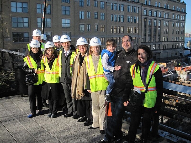 A group poses during a ceremony to celebrate the pouring of the concrete at the new Whitney.