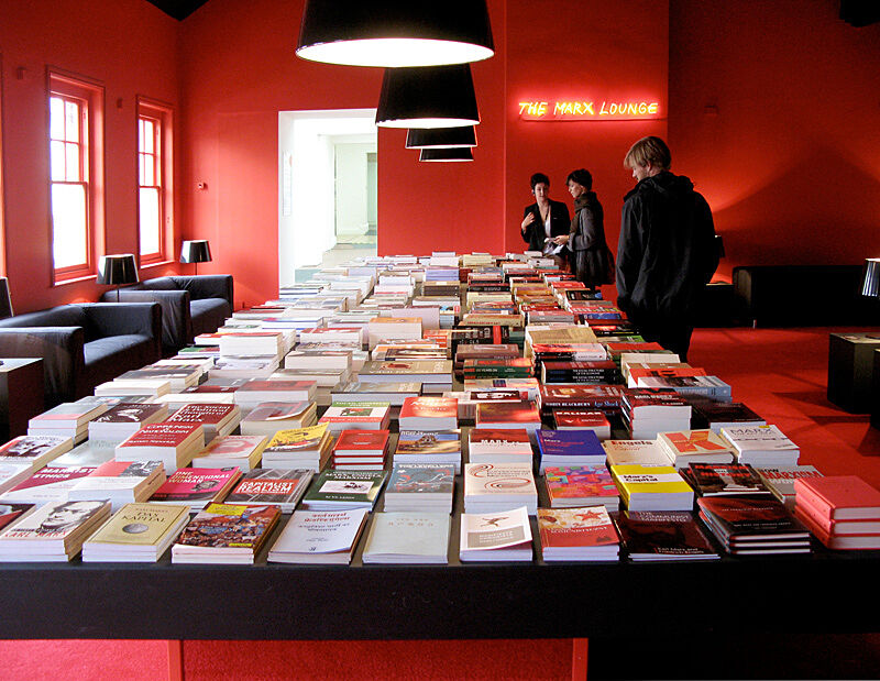Books lined up in a red room.