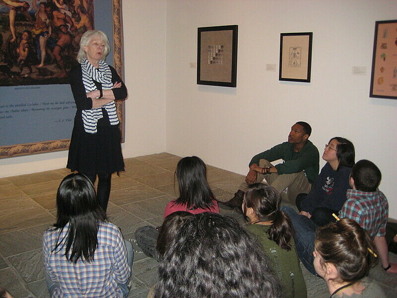 An artist discusses her work in front of students.