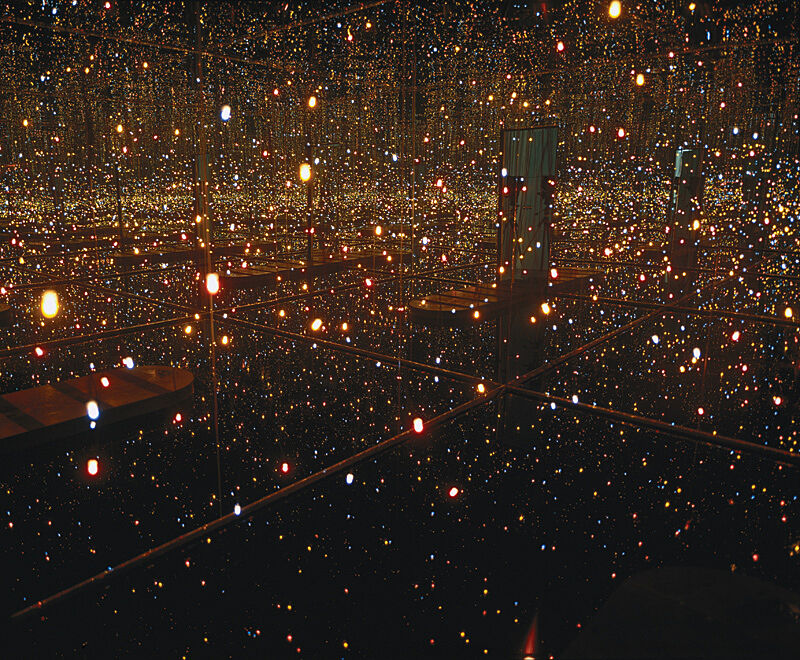 A photograph of a rooms of mirrors and lights reflecting everywhere.