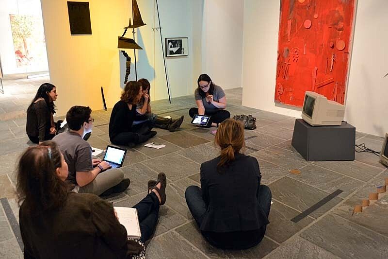 Teachers sit in a gallery to discuss information