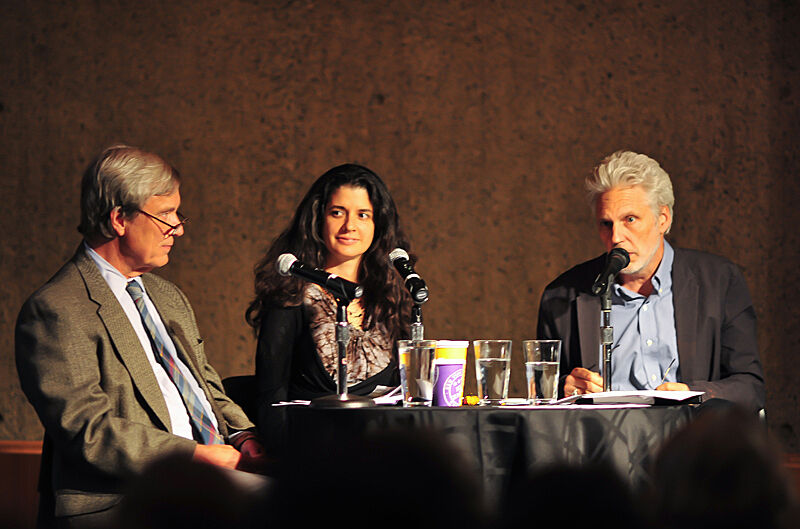 The panelists Robert Langan, Janine Antoni, and Lyle Rexer around a table.