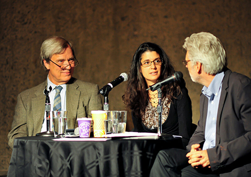 The three panelists talk into microphones.