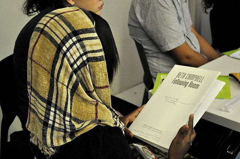 student holding a book in class