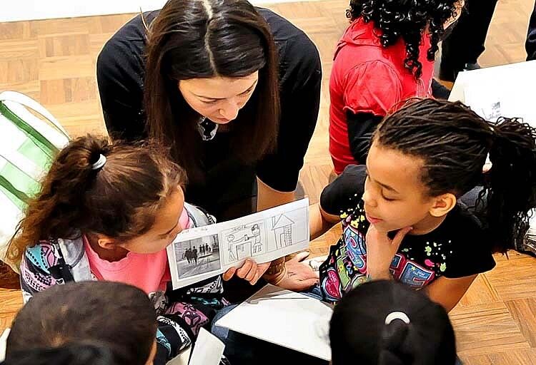 A teacher talking to her students