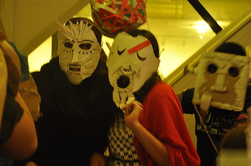 Two guests wear the masks that they made