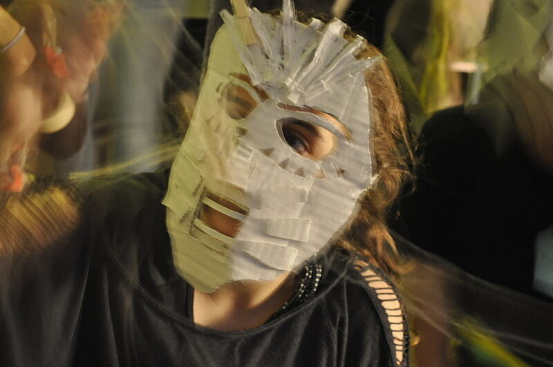 A teen dressed up in a mask