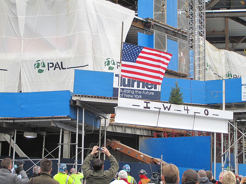 The final beam being raised with a flag on it