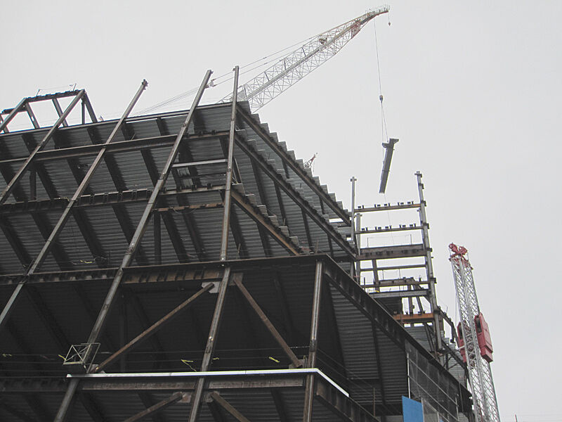 A crane carrying a steel beam