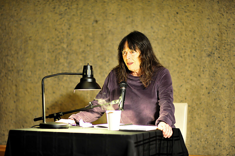 A close up of artist Eleanor Antin as she reads from her book.