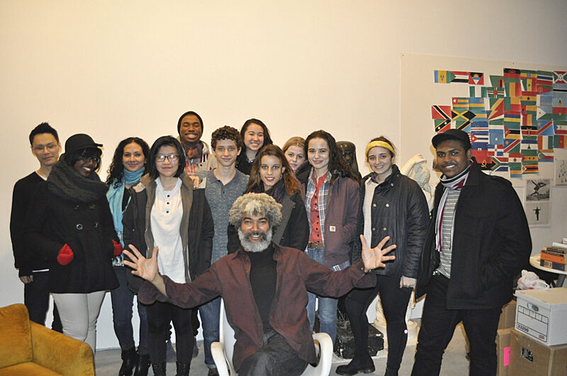 Teens pose for a group picture with artist Fred Wilson in a Brooklyn art studio.