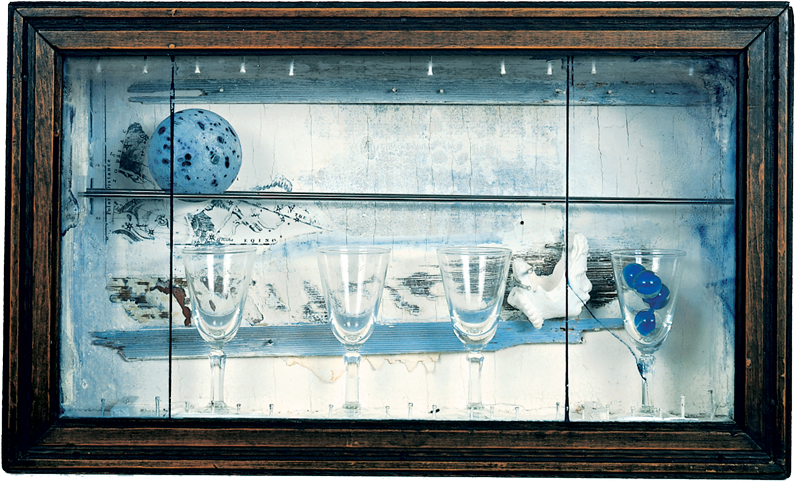 A glass framed wooden box with glassware and objects inside.