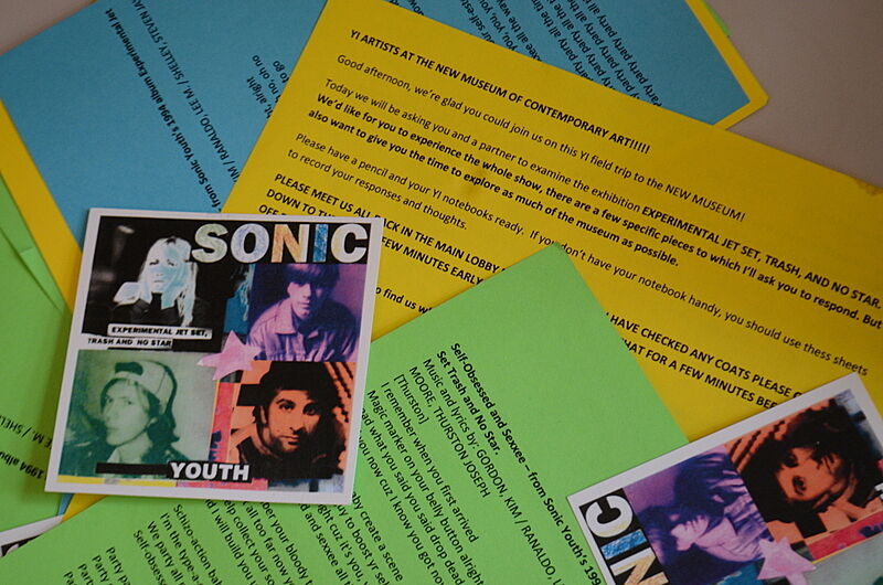colored papers strewn with instructions and album art