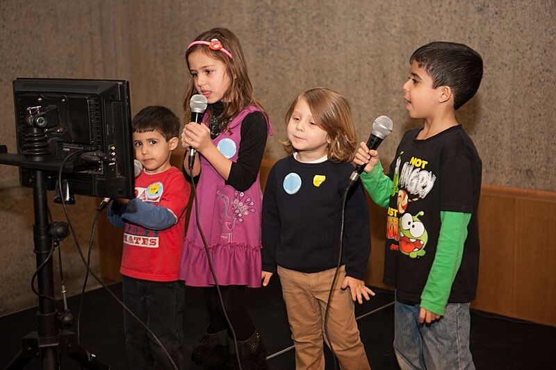 Children singing to the audience
