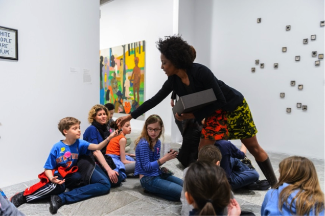 Lorna Simpson hands families examples of the bronze frames used in her work in the exhibition Blues for Smoke.