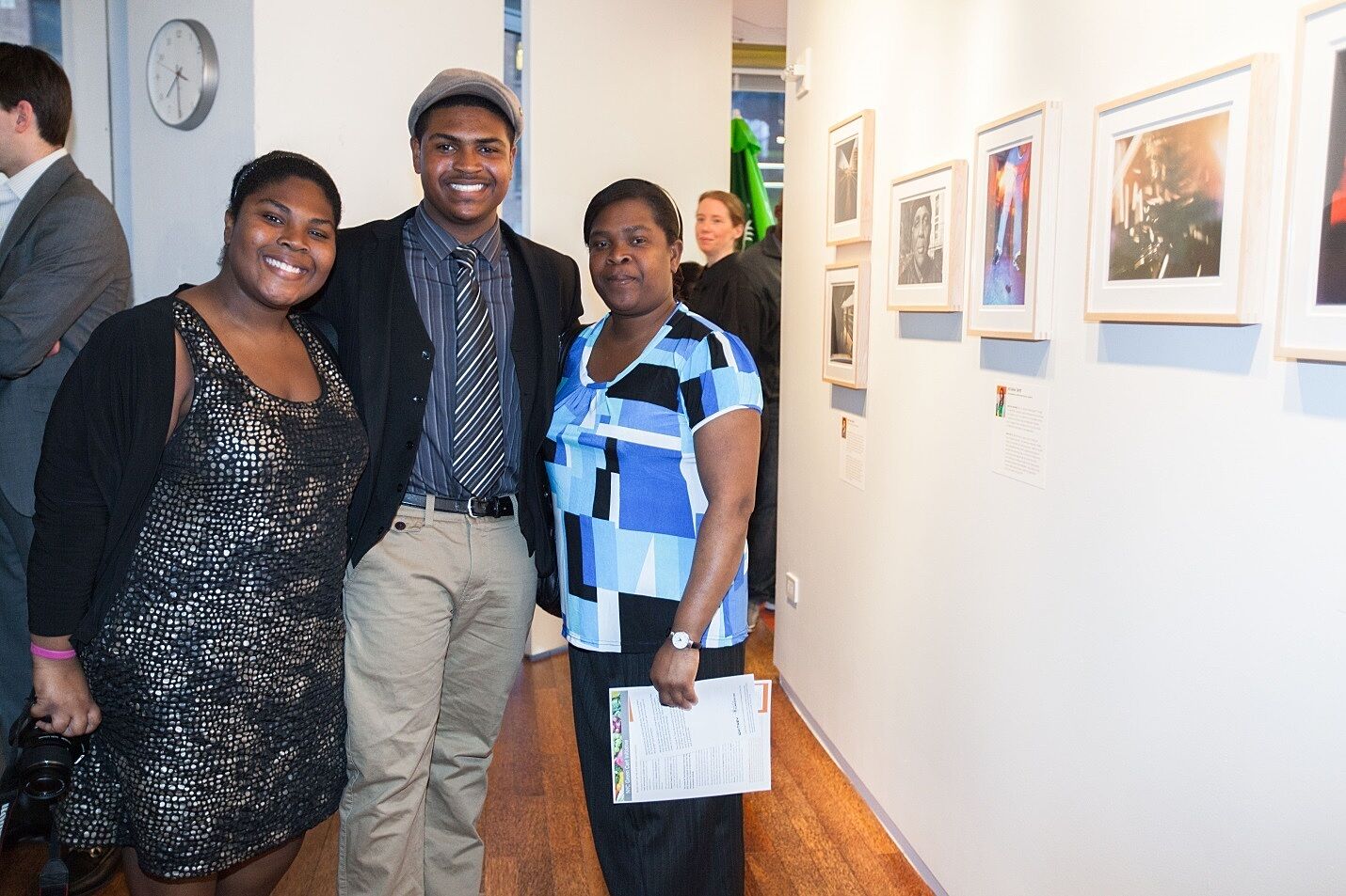 Participant and family pose in gallery.