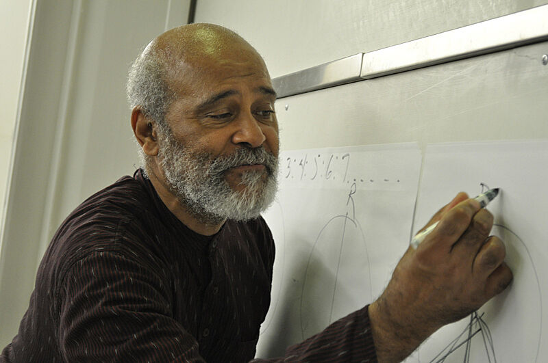 A man draws a diagram on a piece of paper