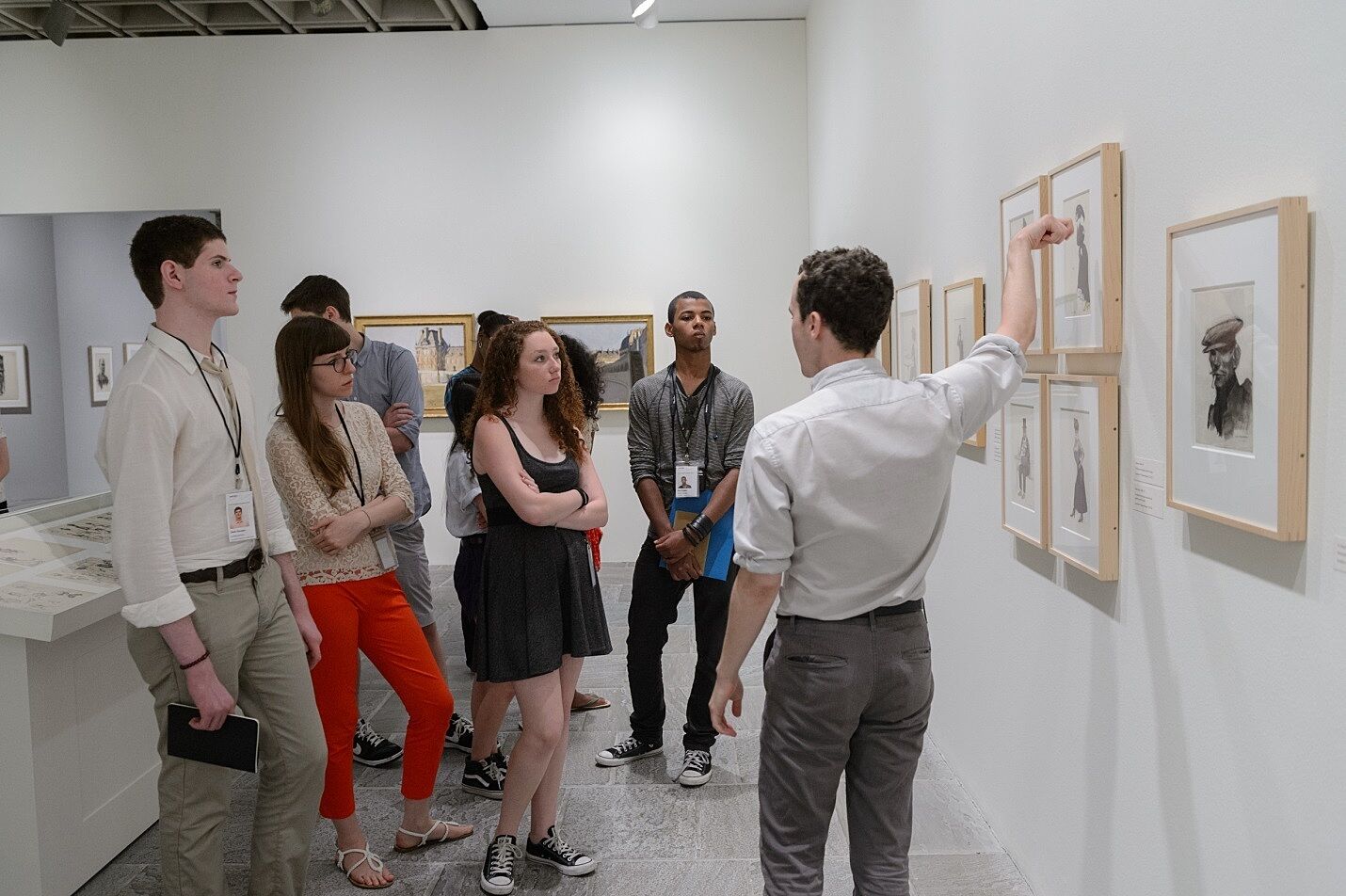 Teens get a tour of the gallery from a museum curator.