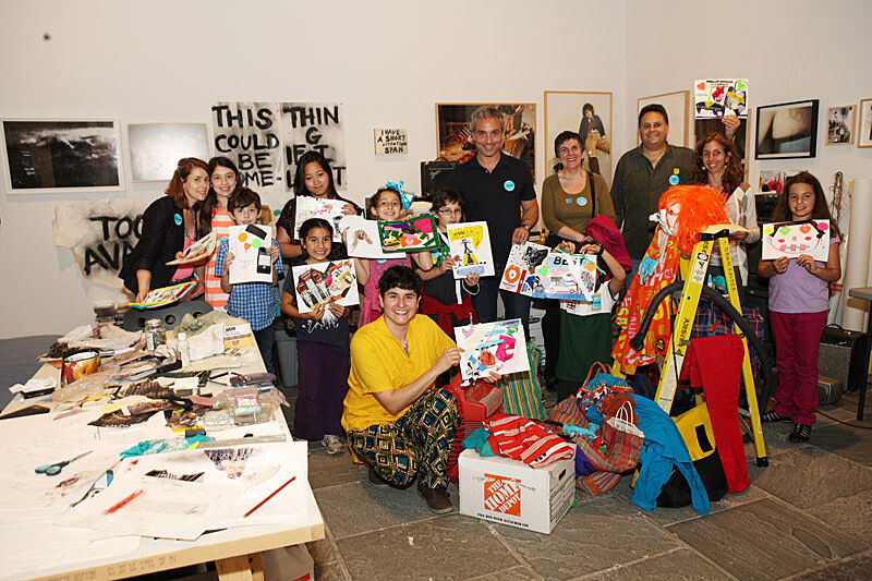 The workshop poses with their art