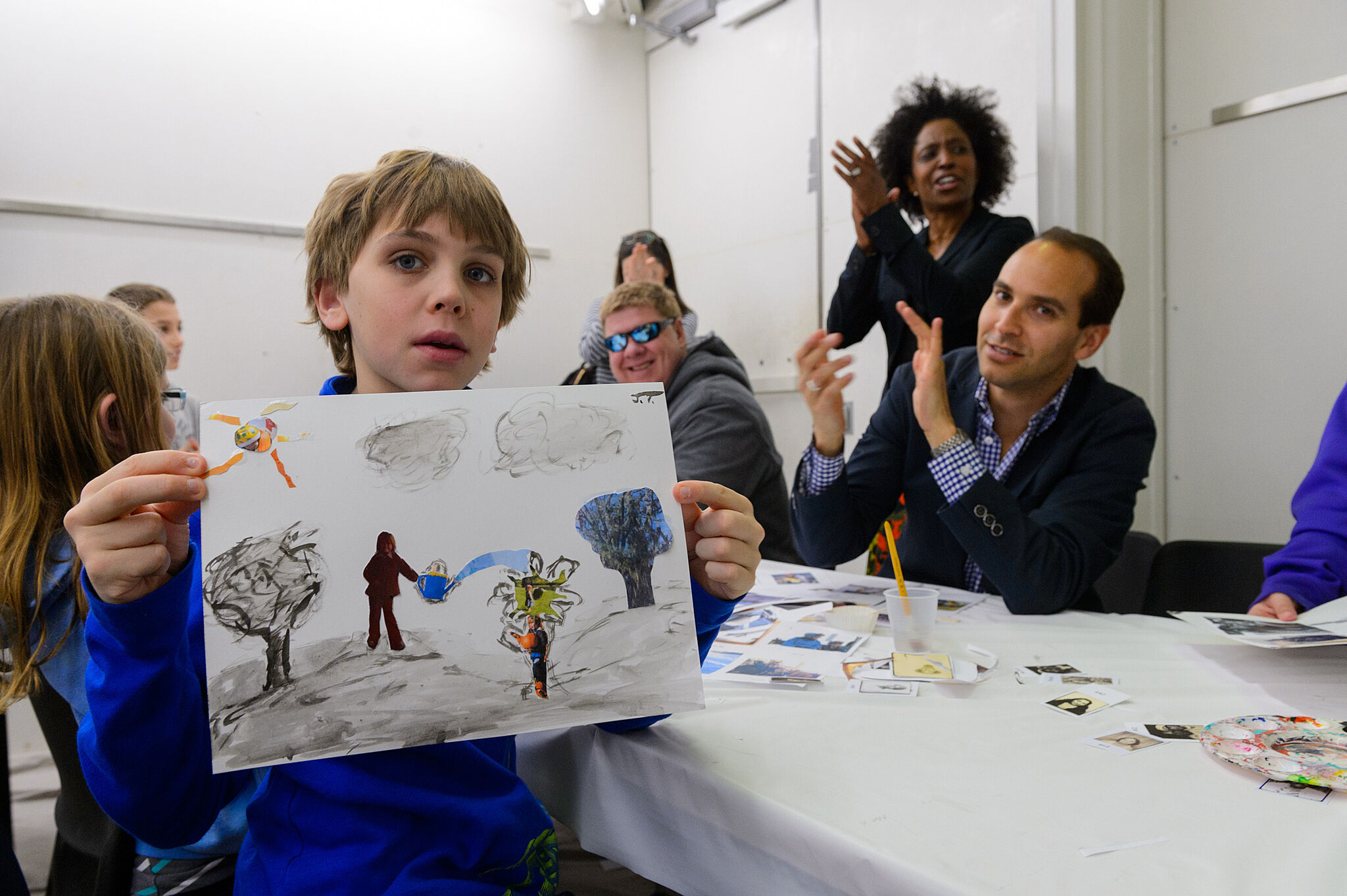 A child shows off his artwork