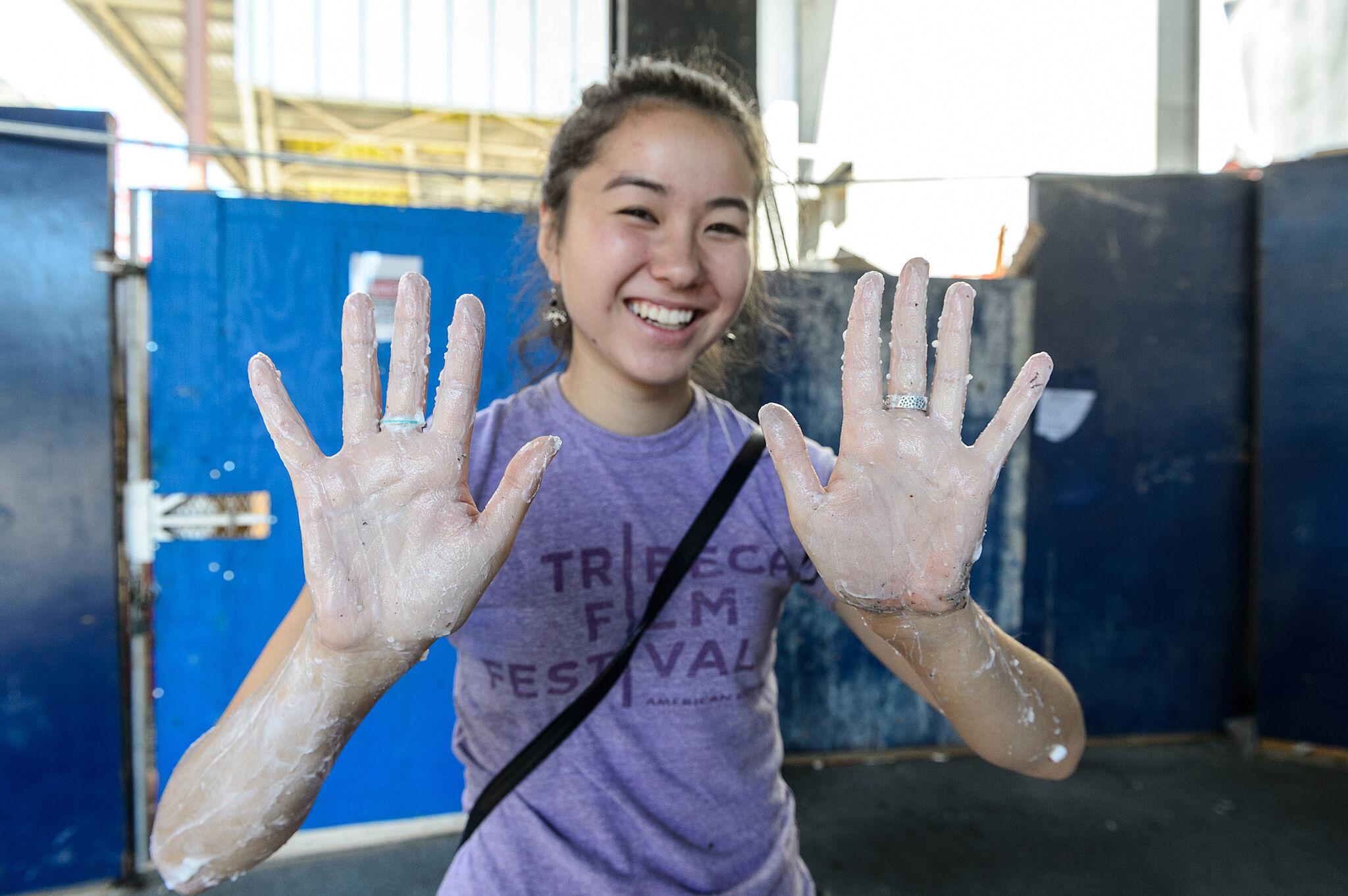 teen showing paste glue on her hands