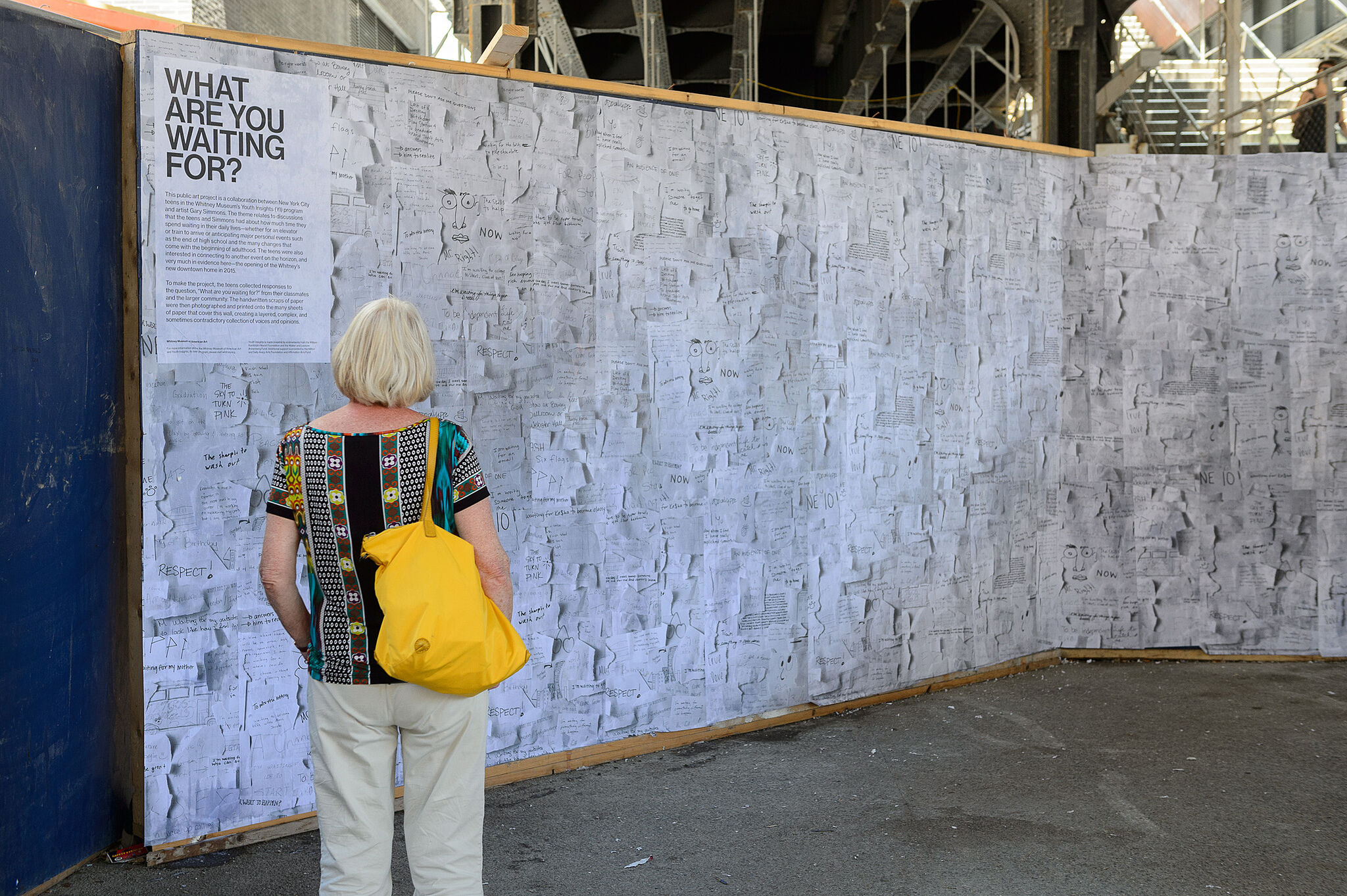 woman looks at exhibition wall