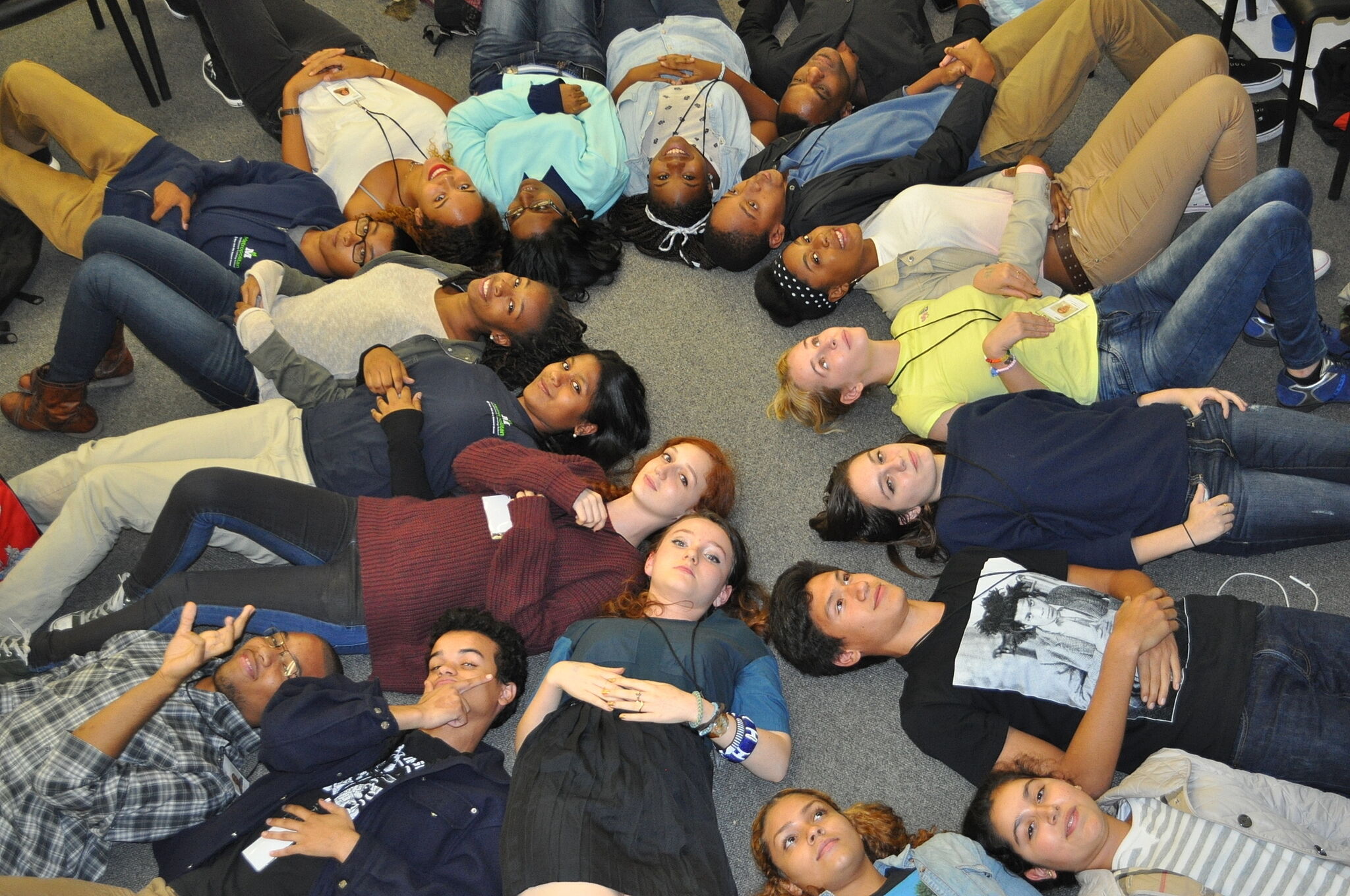 students laying on the floor reflecting on class