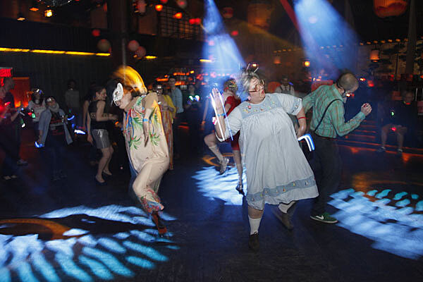 Halloweeners in costume dancing.