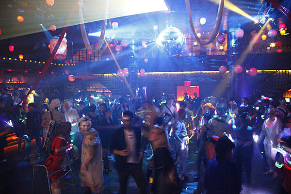 Disco ball illuminates the dance floor.