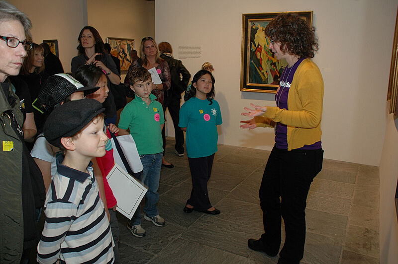 Artist talking with families in gallery