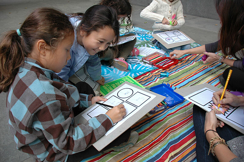 Girls drawing their own comics.