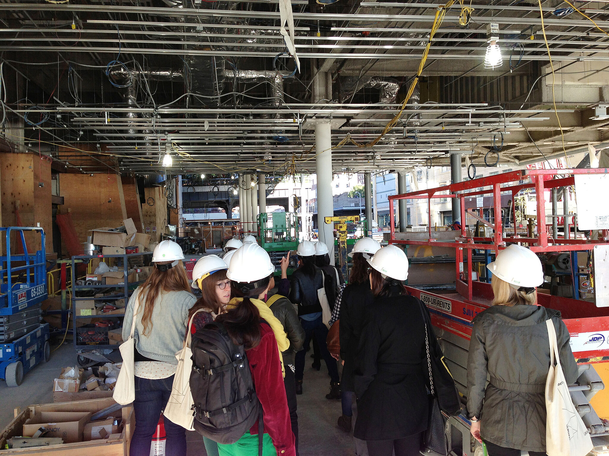A student group tours the entrance area of the new Whitney