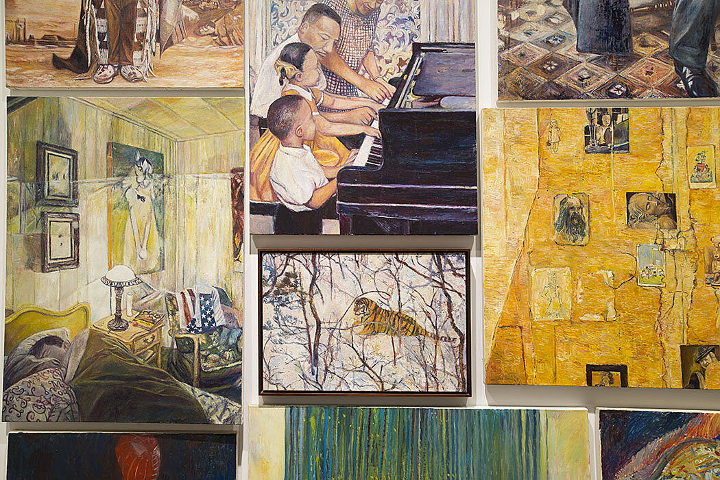 A collage of paintings on a wall.