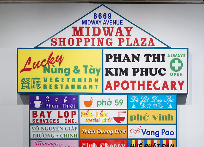 An artwork of various storefront signs in the shape of a storefront.