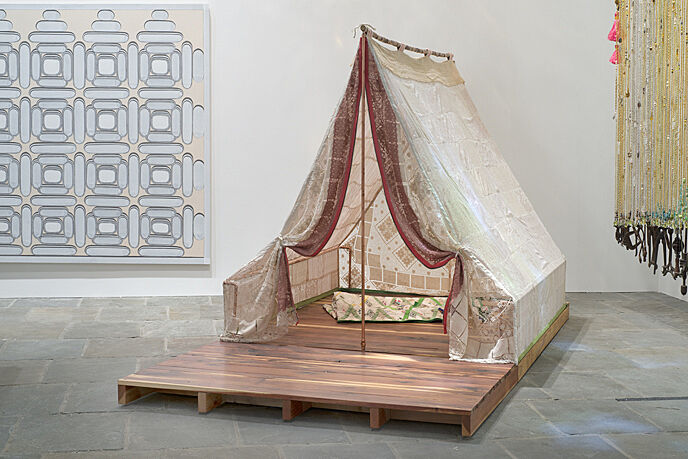 An installation of a tent in a gallery.