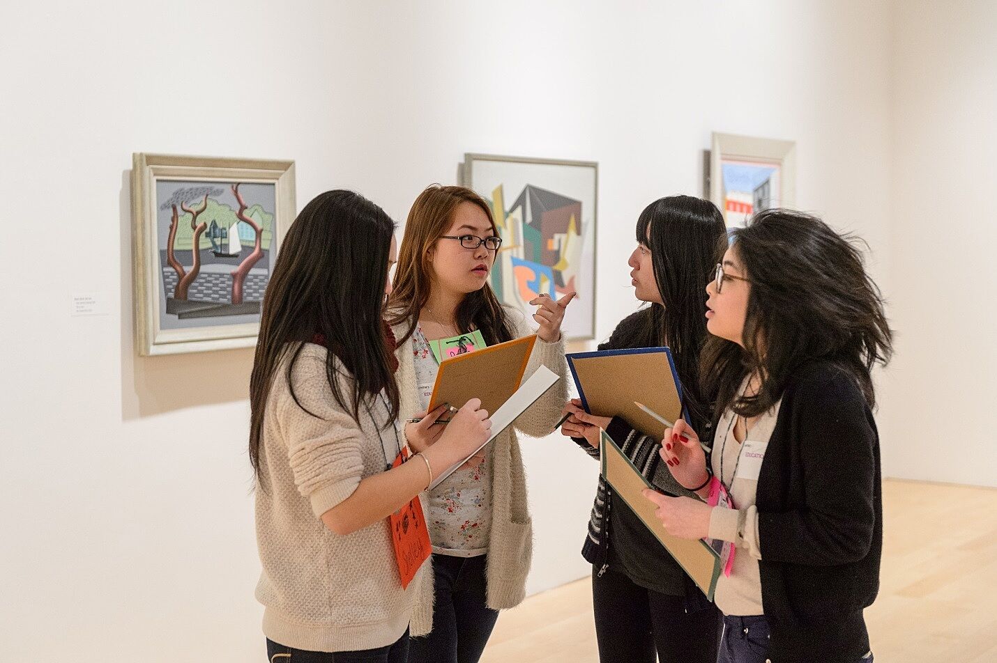 Teens discussing exhibition in galleries.