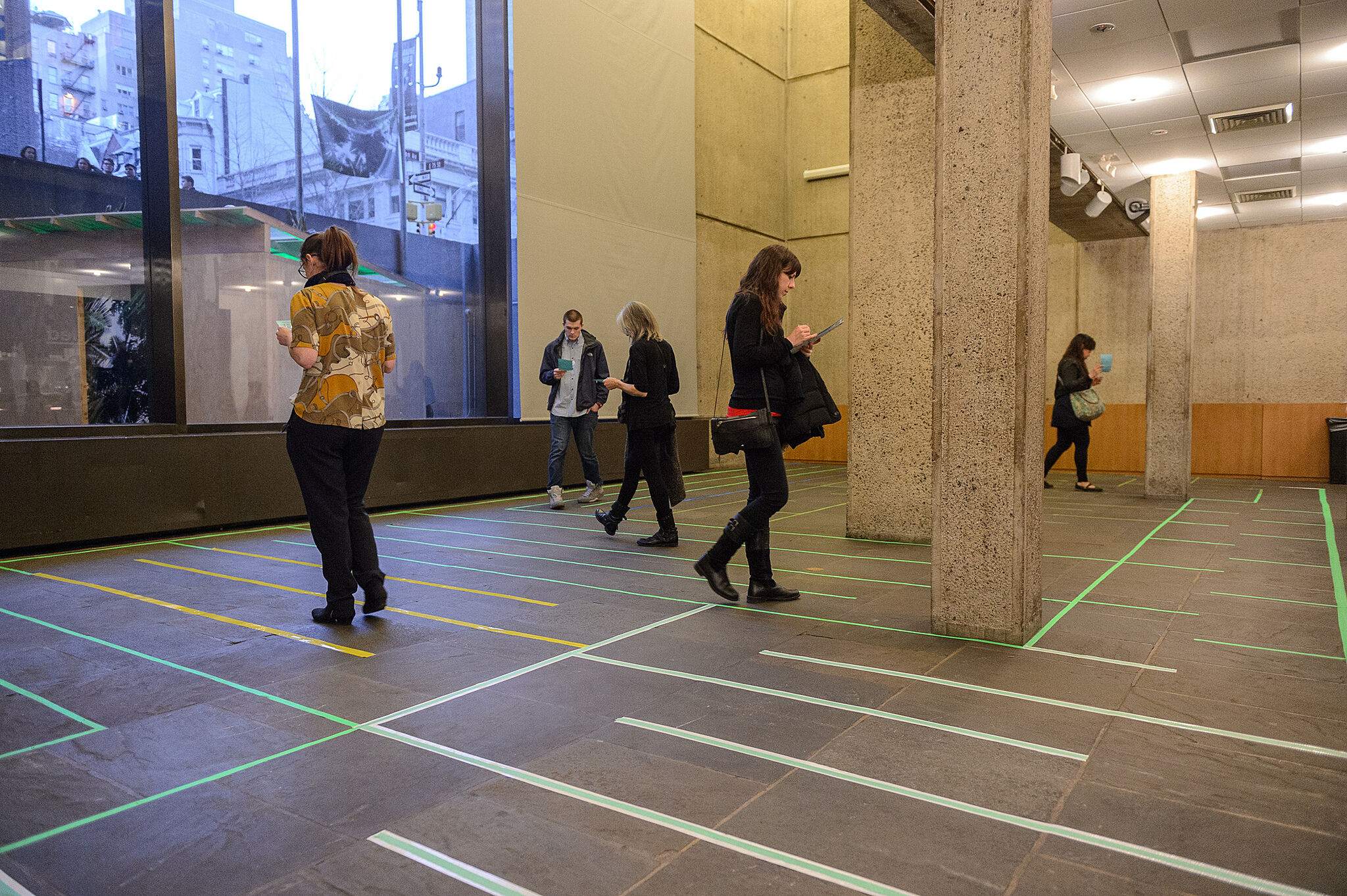 Museum guests walking through a gallery at the Whitney Museum.