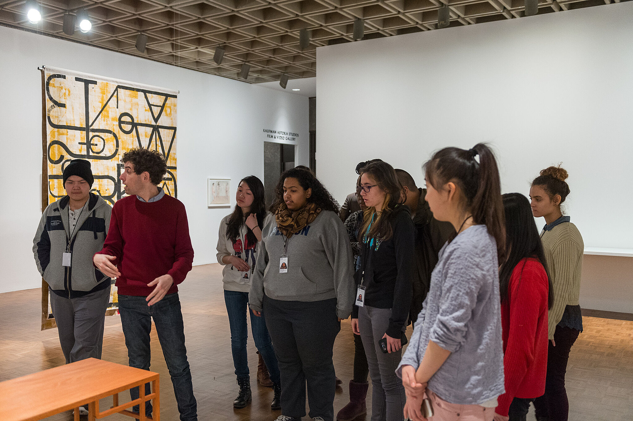 An artist takes a student group on a tour of a gallery.