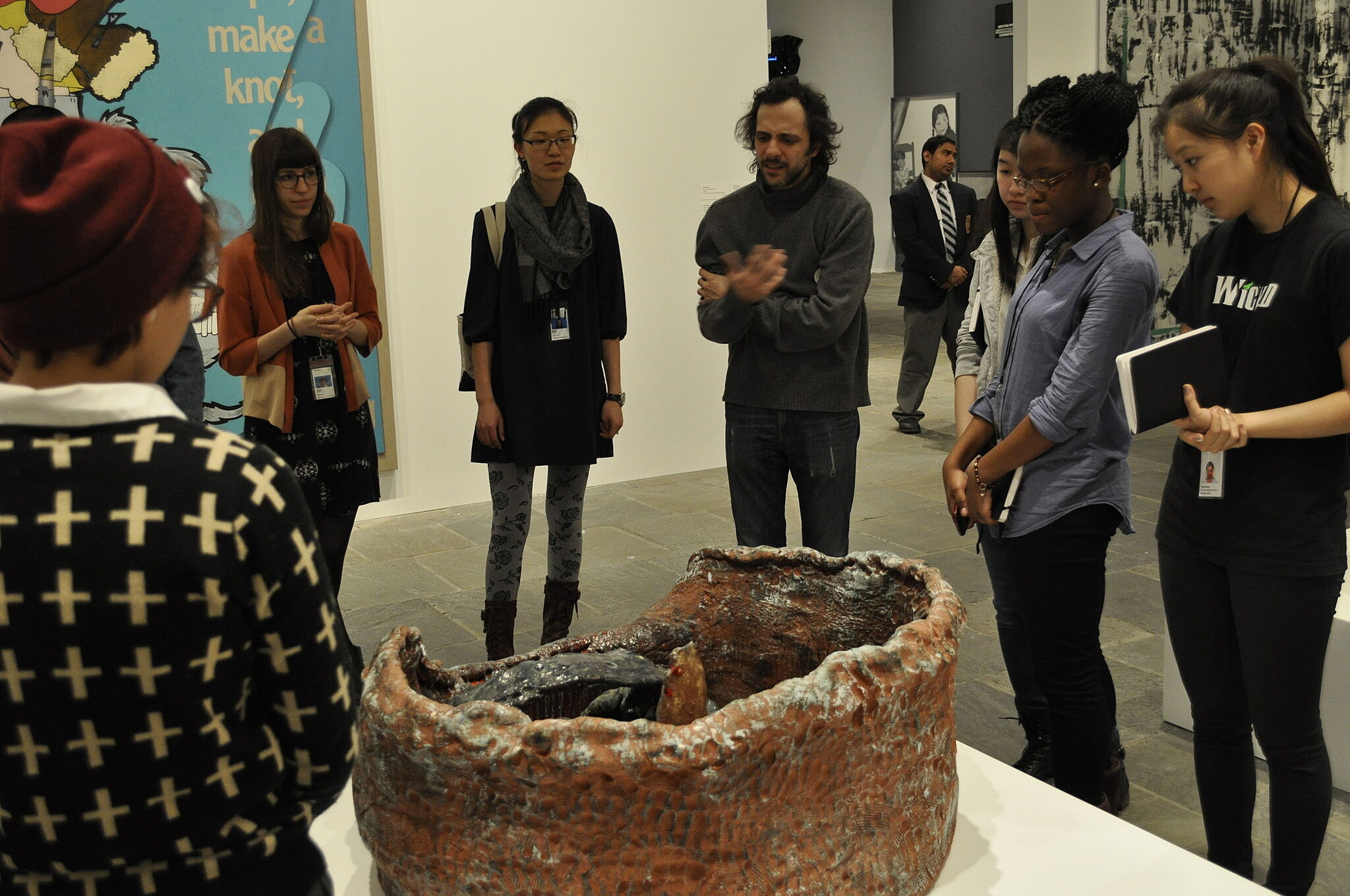 The artist takes youth leaders through a tour of the Biennial exhbiit.