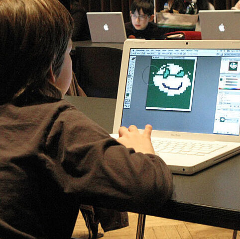 child on laptop drawing artwork