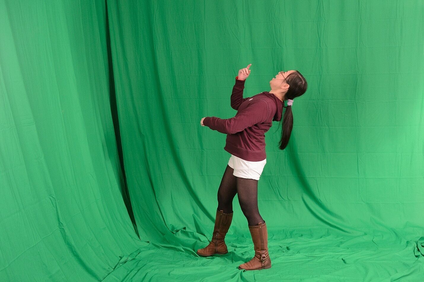 Y I Artist Sally performs in front of the green screen