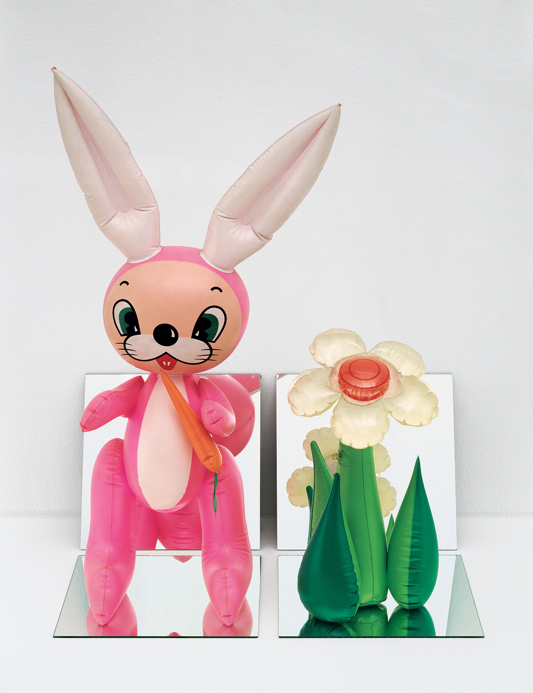 A cartoonish inflatable bunny and flower.