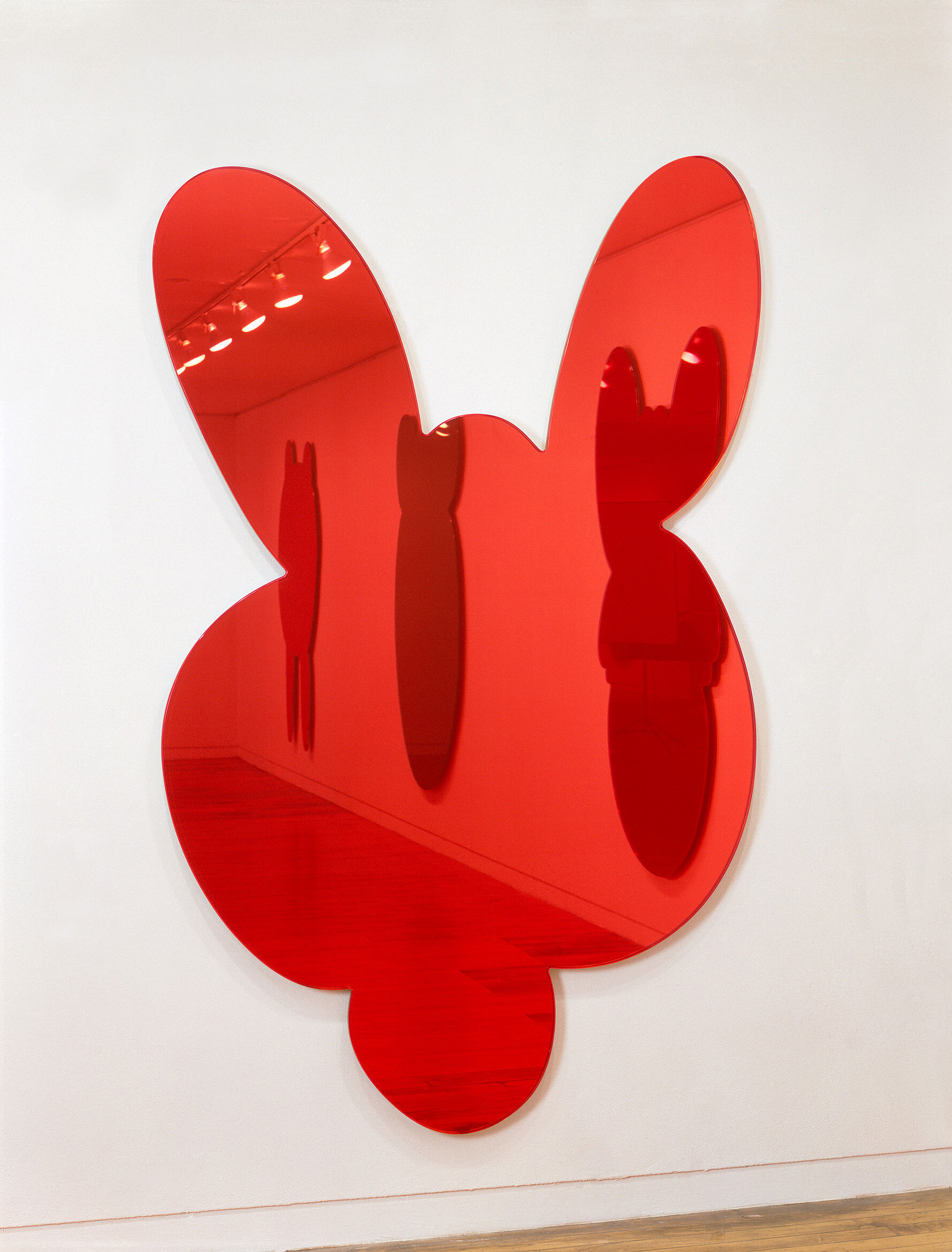 A red-tinted mirror shaped like the head of a kangaroo.