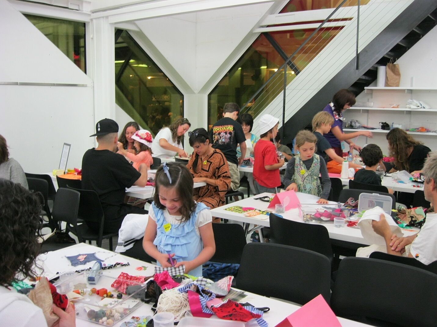 Adults and kids working on a crafts project