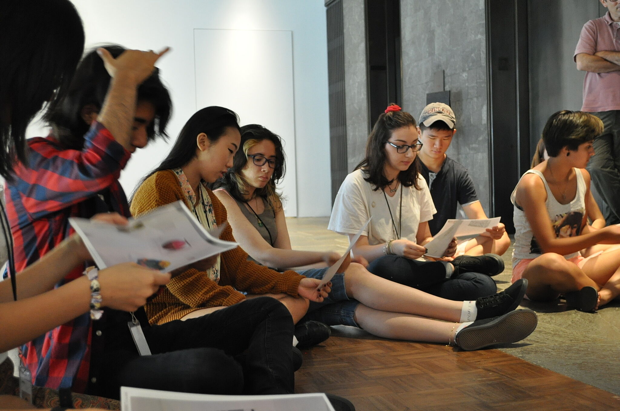 students sitting on floor of museum