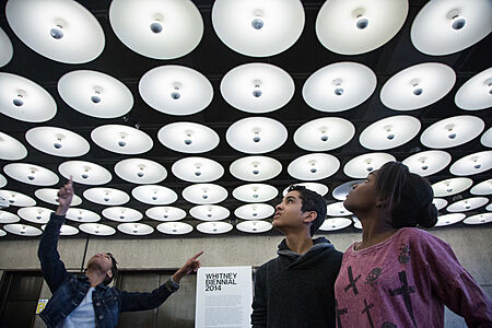 A student points at a light fixture