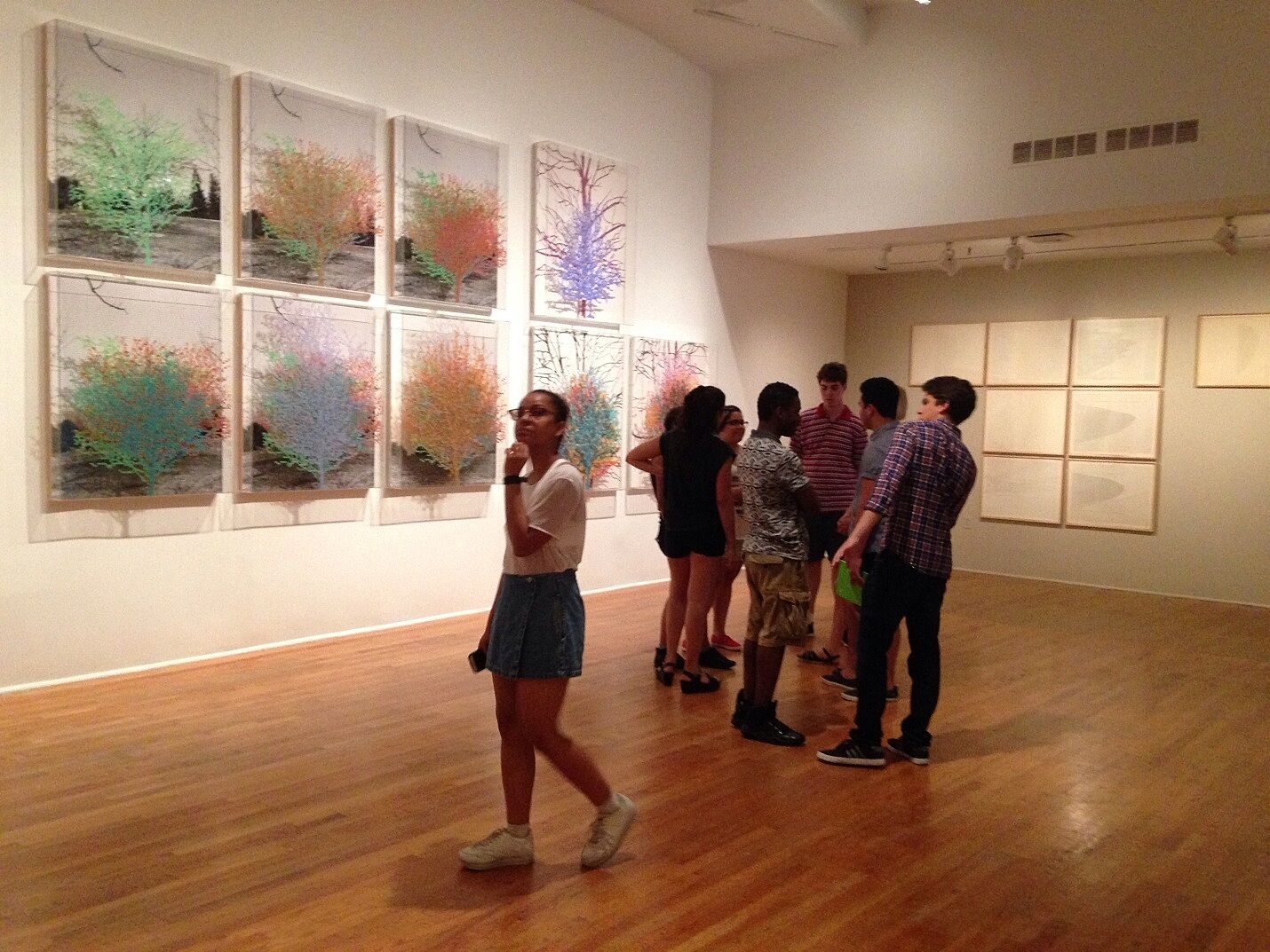 students standing in gallery looking at art