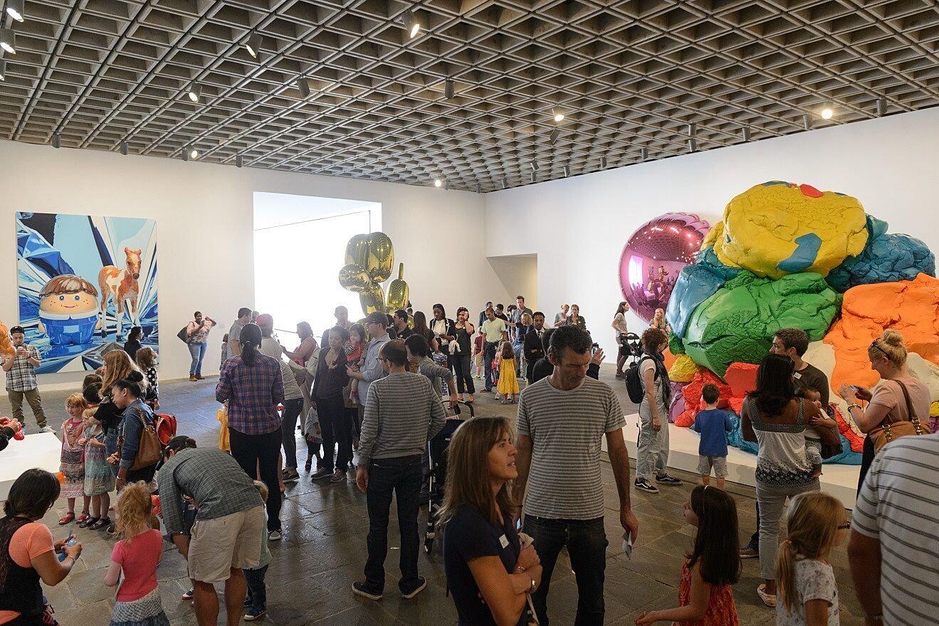 Families tour the Jeff Koons exhibit in the Breuer building.