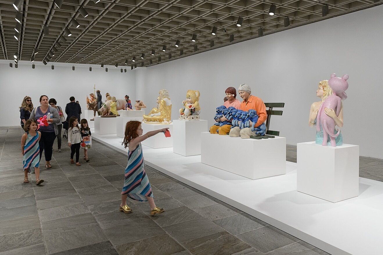 A family explores the Jeff Koons exhibition at the Whitney Museum.