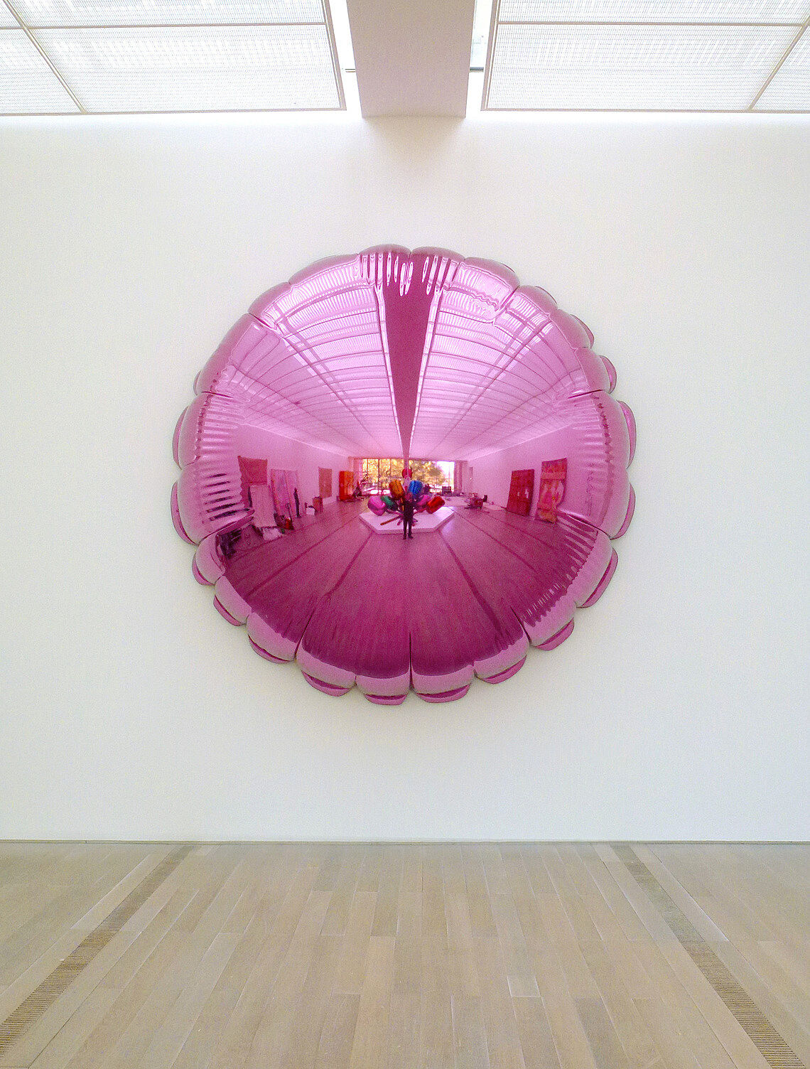 Pink metal balloon on wall.